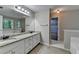 The updated bathroom offers a granite countertop, double vanity, and large mirrors at 3253 Brookshire Way, Duluth, GA 30096