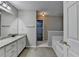 This bathroom offers a large granite vanity, great lighting, and a tub for relaxation at 3253 Brookshire Way, Duluth, GA 30096