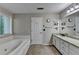 Bathroom features a soaking tub, granite countertop, and a large mirror at 3253 Brookshire Way, Duluth, GA 30096