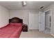 Carpeted bedroom with double door closet and an open door to an adjacent room at 3253 Brookshire Way, Duluth, GA 30096