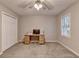 Bedroom features plush carpet, natural light from the window, and a ceiling fan with lighting at 3253 Brookshire Way, Duluth, GA 30096