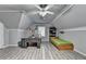 Bonus Room features plank flooring, desk, bed and ceiling fan at 3253 Brookshire Way, Duluth, GA 30096