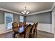 Elegant dining room showcasing a large table, chandelier, and natural light at 3253 Brookshire Way, Duluth, GA 30096