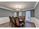 Dining area with a classic table set, chandelier, and gray painted walls at 3253 Brookshire Way, Duluth, GA 30096