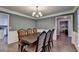 Dining area with a classic table set, chandelier, and door to the kitchen at 3253 Brookshire Way, Duluth, GA 30096