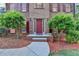Close-up of the front door with decorative landscaping and a brick walkway at 3253 Brookshire Way, Duluth, GA 30096