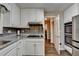 Kitchen with white cabinets, stainless steel appliances, hardwood flooring, and lots of light at 3253 Brookshire Way, Duluth, GA 30096