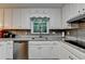 Kitchen featuring stainless appliances, stainless dishwasher, and white cabinets at 3253 Brookshire Way, Duluth, GA 30096