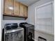 Convenient laundry room with overhead cabinets and modern appliances at 3253 Brookshire Way, Duluth, GA 30096