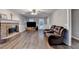 Spacious living room featuring a brick fireplace and comfortable leather seating at 3253 Brookshire Way, Duluth, GA 30096