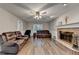 Cozy living room featuring a brick fireplace, hardwood floors, and comfortable seating at 3253 Brookshire Way, Duluth, GA 30096