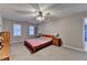 This main bedroom offers natural light, neutral paint, a ceiling fan, and carpeted floors at 3253 Brookshire Way, Duluth, GA 30096