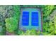 Aerial view of private tennis courts surrounded by lush greenery at 3253 Brookshire Way, Duluth, GA 30096