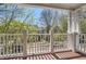 Covered balcony with classic white railings and columns offers a scenic neighborhood view at 489 Carter Se Ave, Atlanta, GA 30317