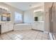 Elegant bathroom featuring tile floors, double vanities, and separate shower and soaking tub at 489 Carter Se Ave, Atlanta, GA 30317