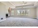 Large bedroom featuring neutral carpet, fireplace, windows with neighborhood views, and recessed lighting at 489 Carter Se Ave, Atlanta, GA 30317