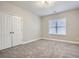 Cozy bedroom featuring neutral carpet, a window with blinds, and a double-door closet at 489 Carter Se Ave, Atlanta, GA 30317