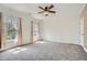 Bright bedroom featuring neutral carpet, a ceiling fan, and natural light from two windows at 489 Carter Se Ave, Atlanta, GA 30317