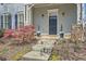 Inviting covered front porch with stone accents, a well-maintained walkway, and stylish landscaping at 489 Carter Se Ave, Atlanta, GA 30317