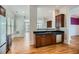 Open kitchen with stainless steel appliances, dark cabinetry, and hardwood flooring at 489 Carter Se Ave, Atlanta, GA 30317