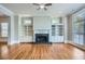 Inviting living room boasts hardwood floors, a ceiling fan, and a cozy fireplace flanked by built-in shelving at 489 Carter Se Ave, Atlanta, GA 30317