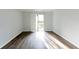 Spacious living room with modern hard surface floors, neutral paint, and sliding glass doors to the deck at 1941 Brian Way # 1941, Decatur, GA 30033