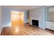 Cozy living room with a fireplace, hardwood floors, and lots of natural light at 1941 Brian Way # 1941, Decatur, GA 30033
