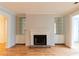 Spacious living room with a classic fireplace, built-in shelving, and hardwood floors at 1941 Brian Way # 1941, Decatur, GA 30033