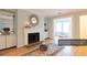 Bright living room featuring a fireplace, hardwood floors, and decorative wall mirror at 1941 Brian Way # 1941, Decatur, GA 30033