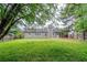 Backyard featuring a lush lawn, mature trees, and patio at 228 Roberts Trl, Locust Grove, GA 30248