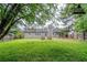 Backyard featuring a lush lawn, mature trees, and fire pit at 228 Roberts Trl, Locust Grove, GA 30248