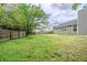 Fenced backyard featuring a lush lawn with trees at 228 Roberts Trl, Locust Grove, GA 30248