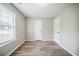 Sun-filled room showcasing wood-look floors and a large window at 228 Roberts Trl, Locust Grove, GA 30248