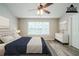 Virtually staged bedroom featuring a vaulted ceiling, a ceiling fan, and large windows at 228 Roberts Trl, Locust Grove, GA 30248