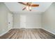 Bright bedroom showcasing wood-look floors and a ceiling fan at 228 Roberts Trl, Locust Grove, GA 30248