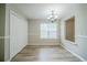 Bright dining room with wood floors, neutral walls and a modern light fixture at 228 Roberts Trl, Locust Grove, GA 30248