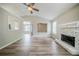 Spacious living room with a fireplace and open layout to the dining area at 228 Roberts Trl, Locust Grove, GA 30248
