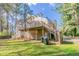 Exterior shot of a house showcasing a wooden deck and spacious backyard at 752 Alison Jane Ne Ct, Kennesaw, GA 30144