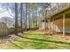 Spacious backyard with grass, trees, and a view of the home's elevated deck at 752 Alison Jane Ne Ct, Kennesaw, GA 30144