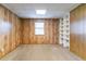 Finished basement with wood paneling, carpet, built-in shelves and a window at 752 Alison Jane Ne Ct, Kennesaw, GA 30144