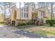 View of the two-story home with wood and stone and a wooden stair walkway up to the front door at 752 Alison Jane Ne Ct, Kennesaw, GA 30144