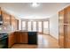 Kitchen featuring wooden floors, cabinets, stainless sink, and black appliances at 752 Alison Jane Ne Ct, Kennesaw, GA 30144