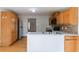 View of the kitchen with stainless steel appliances, hardwood floors, and white countertops at 752 Alison Jane Ne Ct, Kennesaw, GA 30144