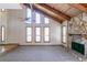 Living room features a soaring ceiling, stone fireplace, and large windows at 752 Alison Jane Ne Ct, Kennesaw, GA 30144