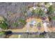 An aerial view of the property and neighborhood highlighting the landscape and surrounding houses at 76 Riverbend Trl, Douglasville, GA 30134