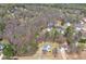 An aerial view of the neighborhood showing the house and wooded surroundings at 76 Riverbend Trl, Douglasville, GA 30134