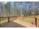 A charming wooden deck overlooks a treed lot at 76 Riverbend Trl, Douglasville, GA 30134