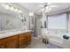 Relaxing bathroom featuring a soaking tub, a separate shower, and a double vanity at 76 Riverbend Trl, Douglasville, GA 30134