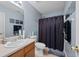 Bathroom featuring a neutral vanity, black shower curtain and blue paint at 76 Riverbend Trl, Douglasville, GA 30134