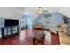 Bonus room featuring beautiful wood floors, a ceiling fan, and a TV set at 76 Riverbend Trl, Douglasville, GA 30134
